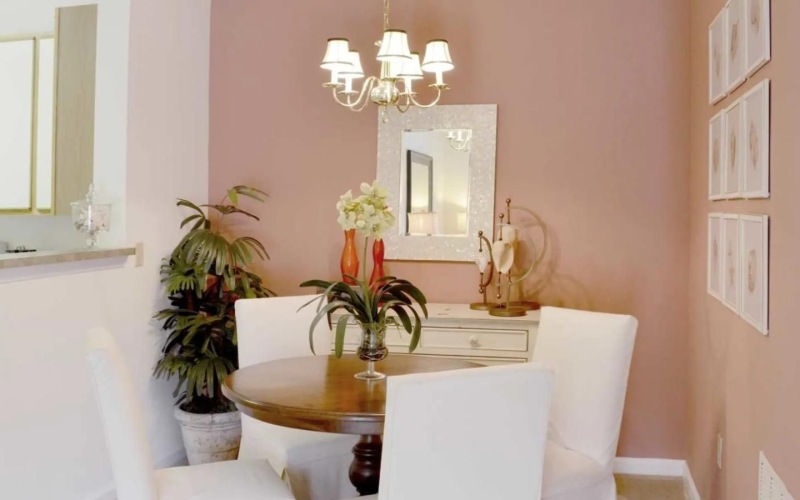 a dining room table with a chandelier above it